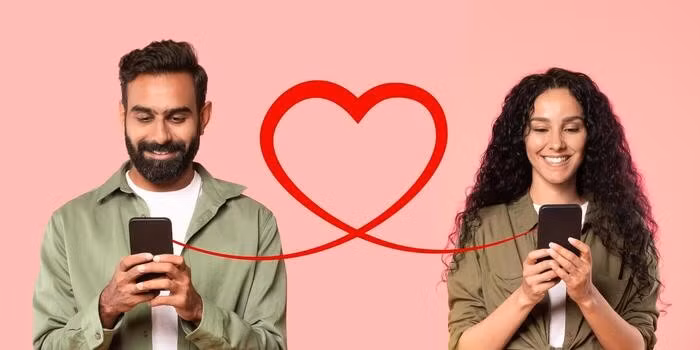 a-man-with-a-beard-in-an-olive-shirt-smiles-at-his-smartphone-and-a-woman-with-curly-hair-photo.jpg.avif